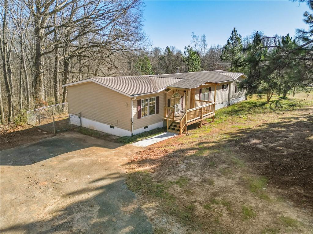 5498 Woodlin Road Lula, GA 30554 - Photo 29 of 40 a view of a house with a yard