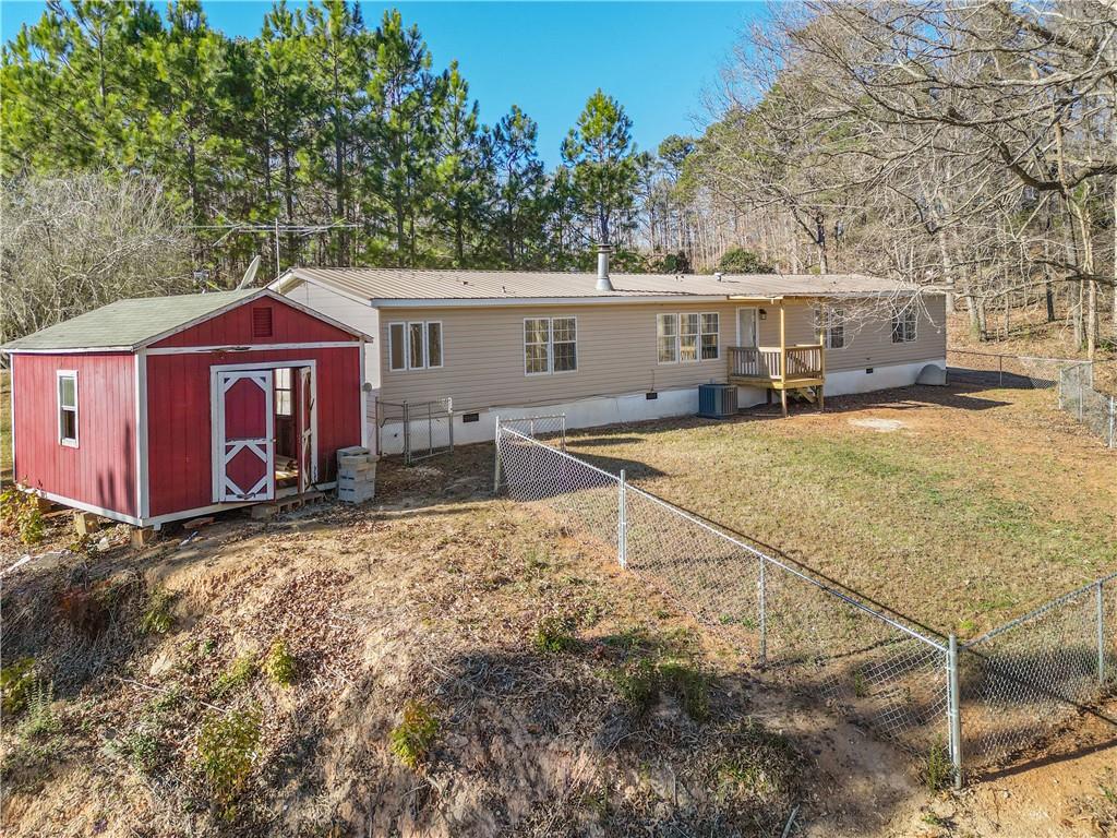 5498 Woodlin Road Lula, GA 30554 - Photo 33 of 40 a front view of a house with a yard and garage