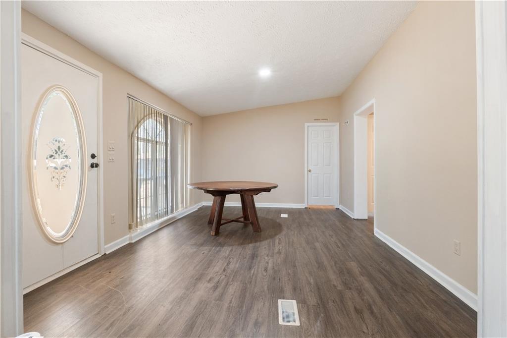 5498 Woodlin Road Lula, GA 30554 - Photo 6 of 40 a view of livingroom with furniture and wooden floor