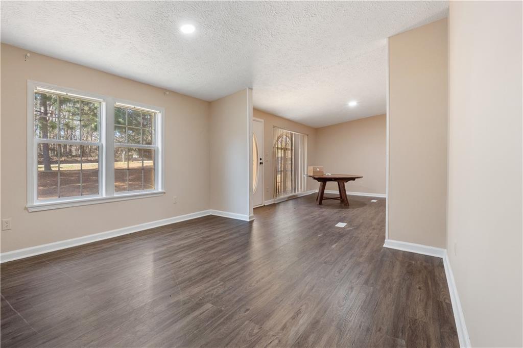 5498 Woodlin Road Lula, GA 30554 - Photo 7 of 40 a view of a room with wooden floor and a window