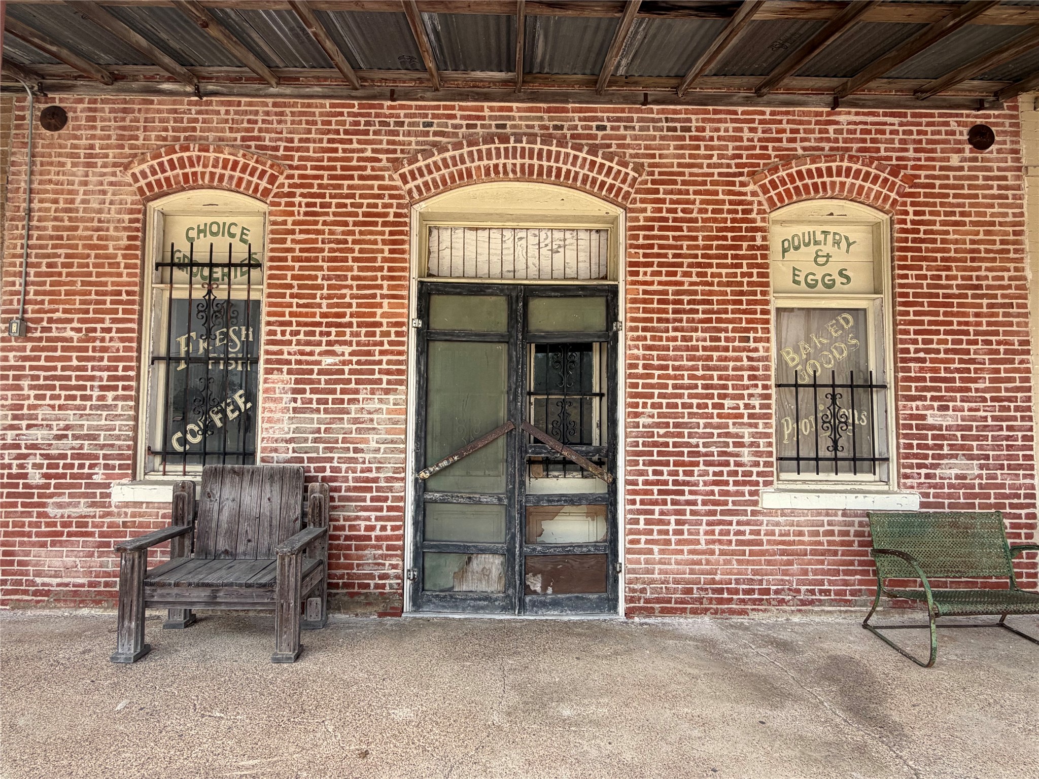 118 Edmonson Ranch Road McDade, TX 78650 - Photo 14 of 16 Doorway to property with brick siding and a porch on old Hwy 20