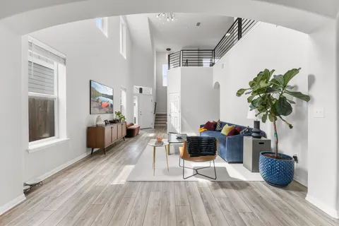 a living room with furniture and a potted plant