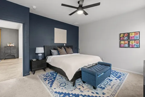 a bedroom with a large bed and a window