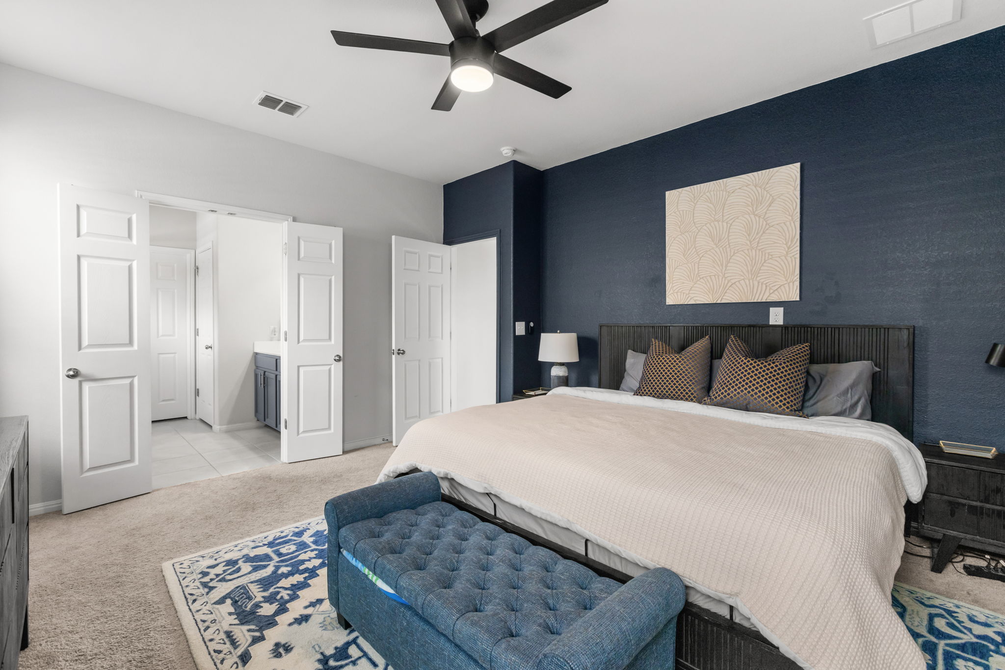 6402 Rafferty Lane Austin, TX 78747 - Photo 13 of 32 a spacious bedroom with a bed and cabinet