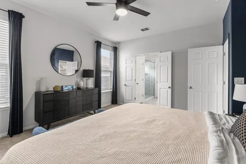 a bedroom with a bed and a mirror