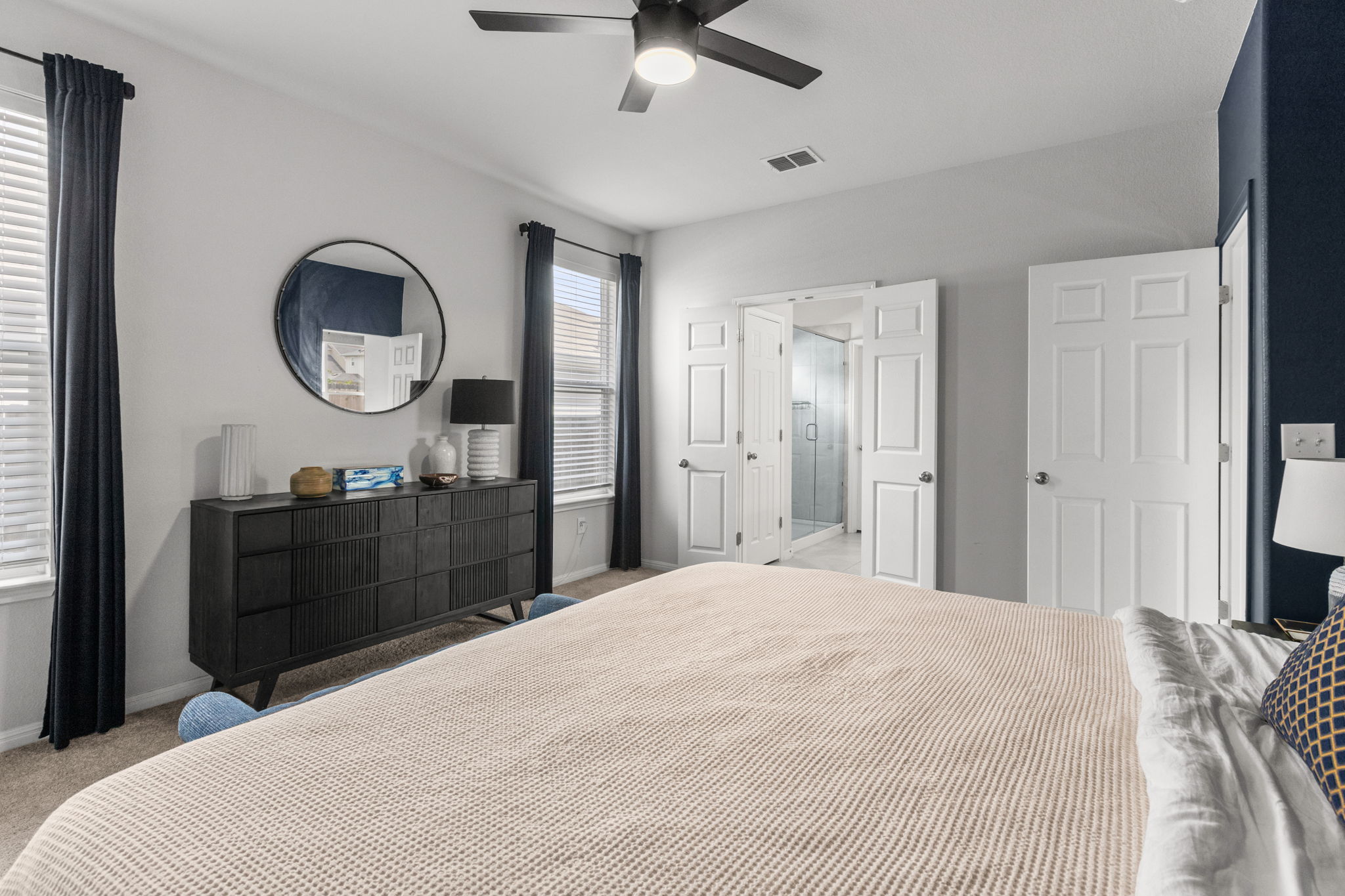 6402 Rafferty Lane Austin, TX 78747 - Photo 14 of 32 a bedroom with a bed and a mirror