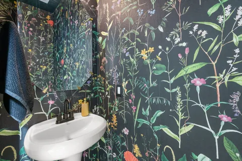 a bathroom with a sink and mirror with toilet