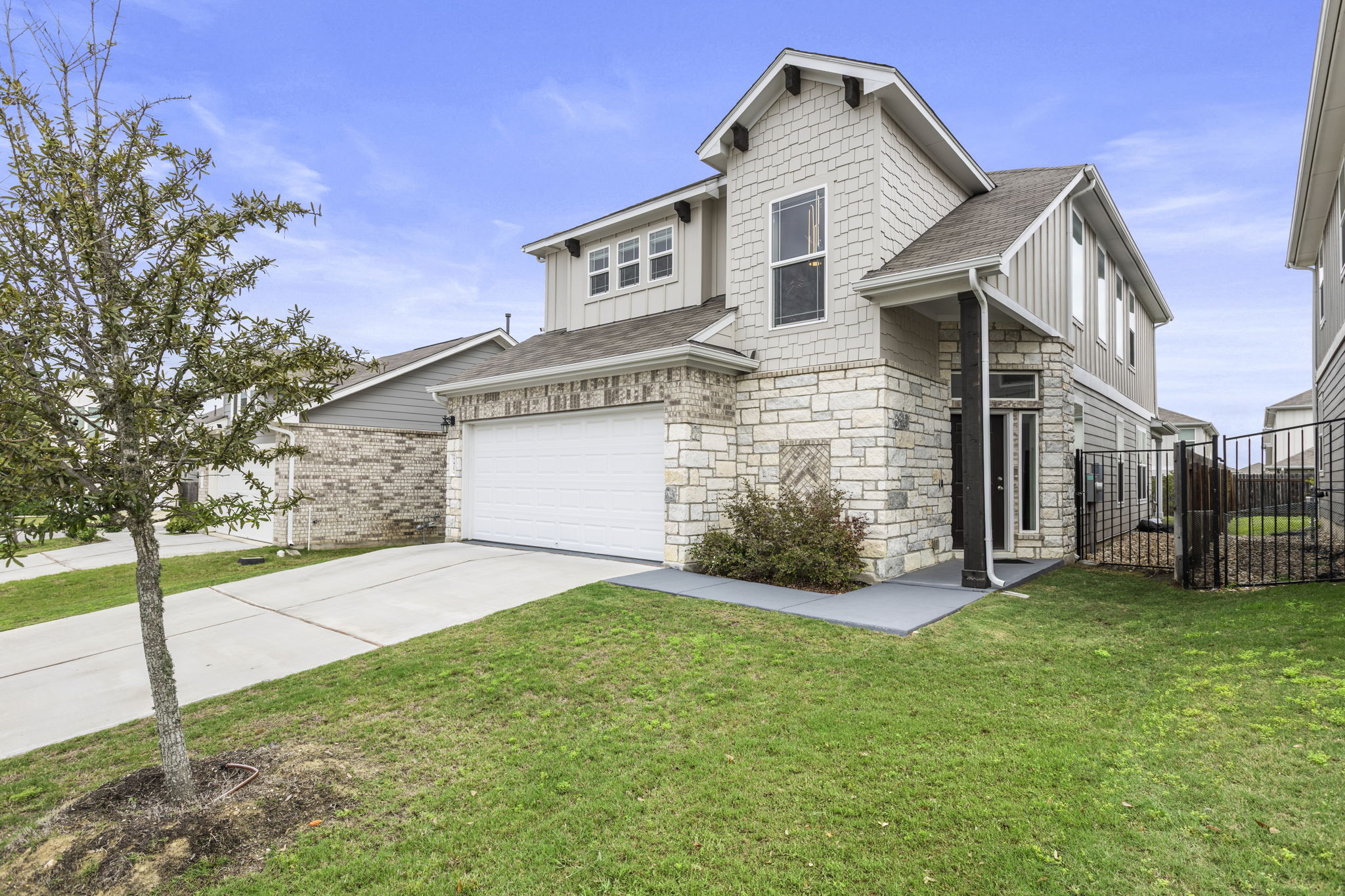 6402 Rafferty Lane Austin, TX 78747 - Photo 2 of 32 a front view of a house with a yard and garage