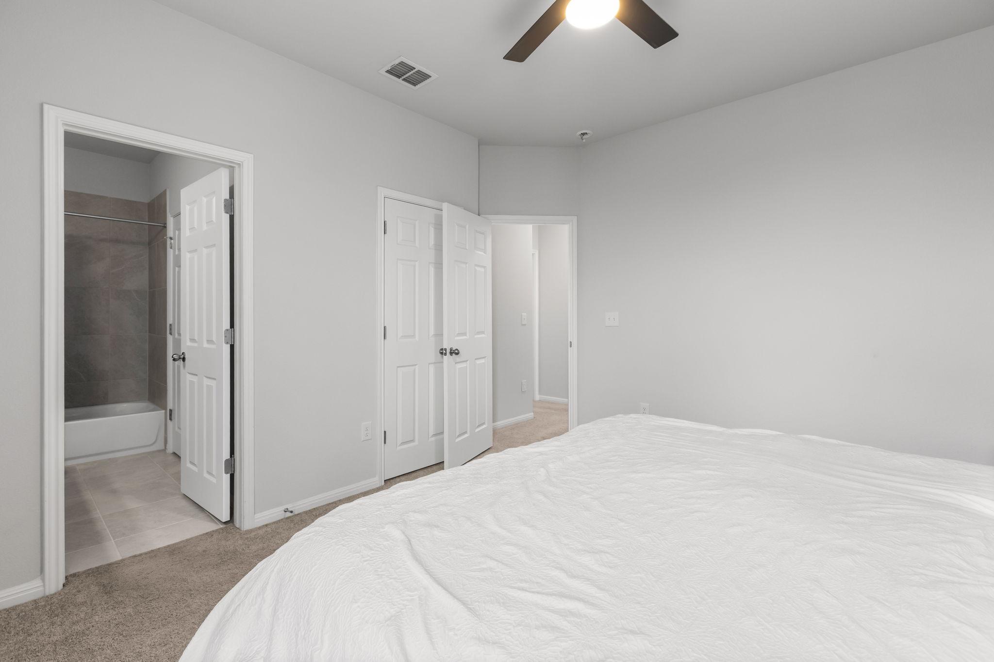 6402 Rafferty Lane Austin, TX 78747 - Photo 23 of 32 a bedroom with a bed and a chandelier fan