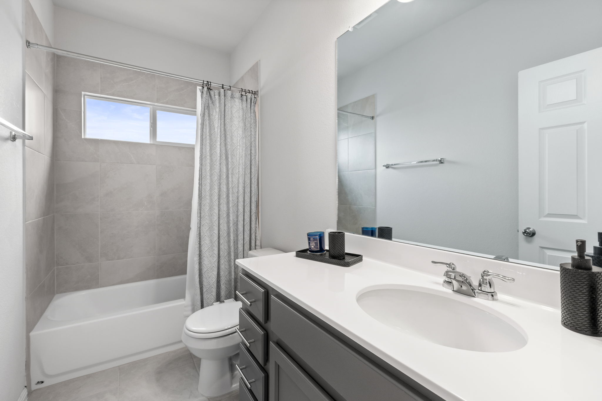 6402 Rafferty Lane Austin, TX 78747 - Photo 24 of 32 a bathroom with a sink a toilet and shower