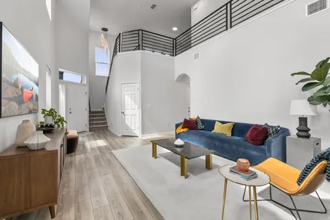 a living room with furniture and wooden floor