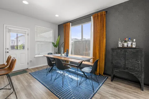 a dining room with furniture and wooden floor