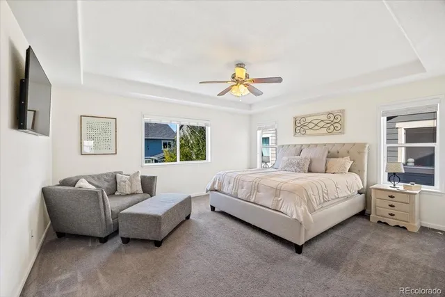 a spacious bedroom with a bed and a couch