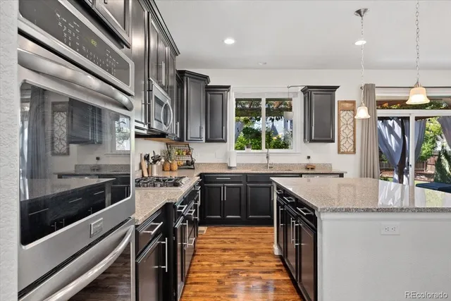 a kitchen with stainless steel appliances granite countertop a sink and stove