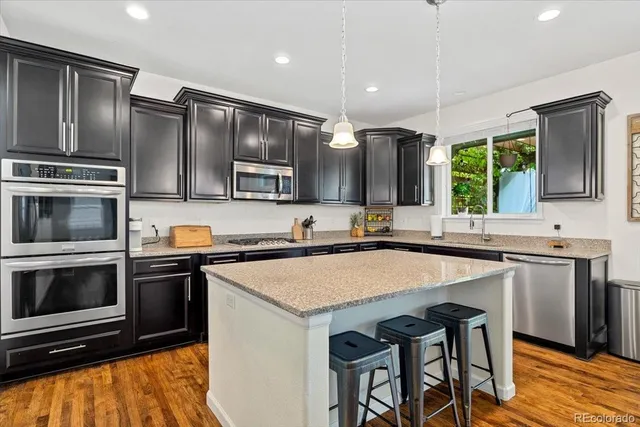 a kitchen with a stove a sink and a microwave
