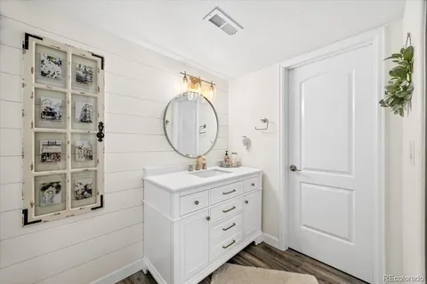 a view of a house with backyard and a tree