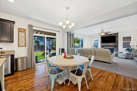 a view of a dining room with furniture wooden floor and chandelier