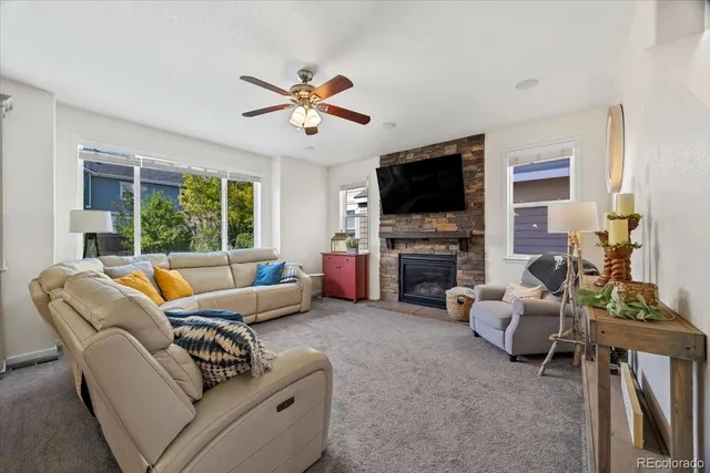 a living room with furniture a fireplace and a flat screen tv