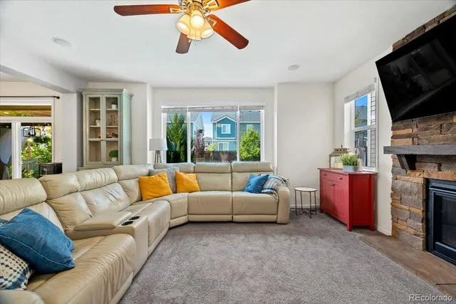 a living room with furniture fireplace and flat screen tv