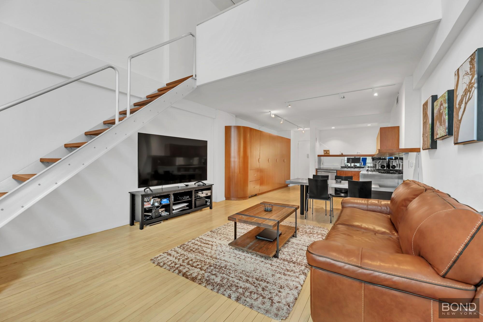 32 East 76th Street, Unit 502602 Manhattan, NY 10021 - Photo 1 of 8 a living room with furniture and a flat screen tv