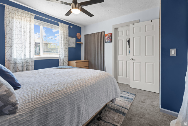 3951 Brixton Road Salt Lake City, UT 84129 - Photo 14 of 22 Carpeted room featuring a ceiling fan with integrated lighting, a window with white trim, and a built-in closet with paneled bifold doors