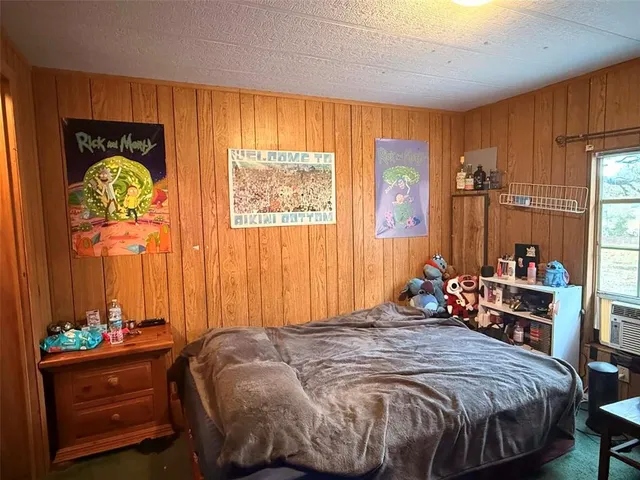 a bedroom with a bed and a table in it