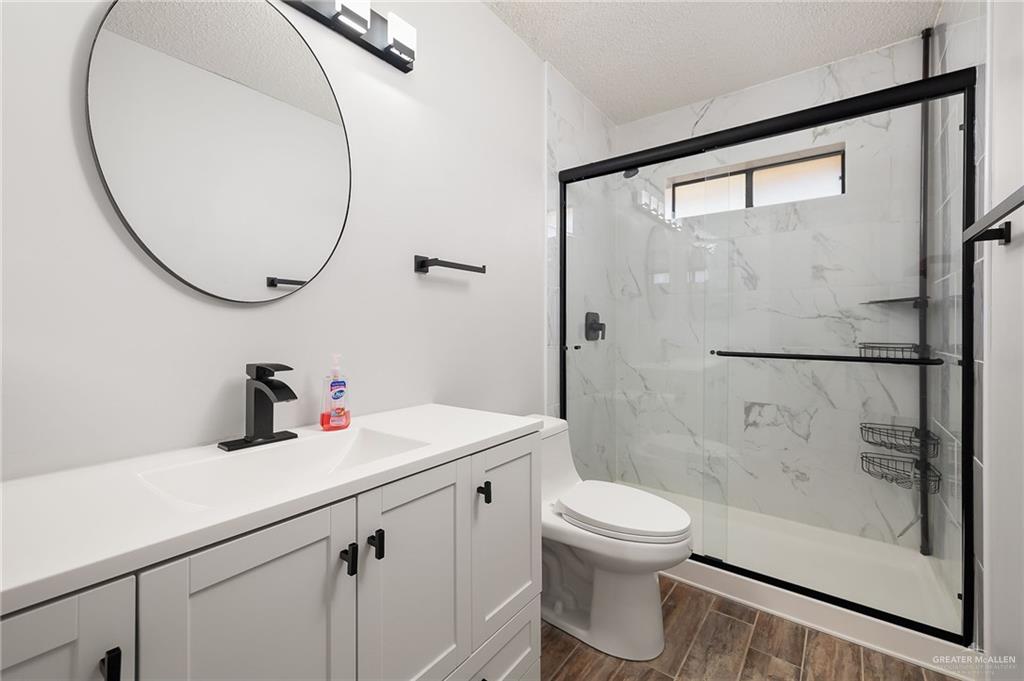 1815 Wilson Street Mission, TX 78572 - Photo 12 of 16 a bathroom with a sink a toilet and a mirror