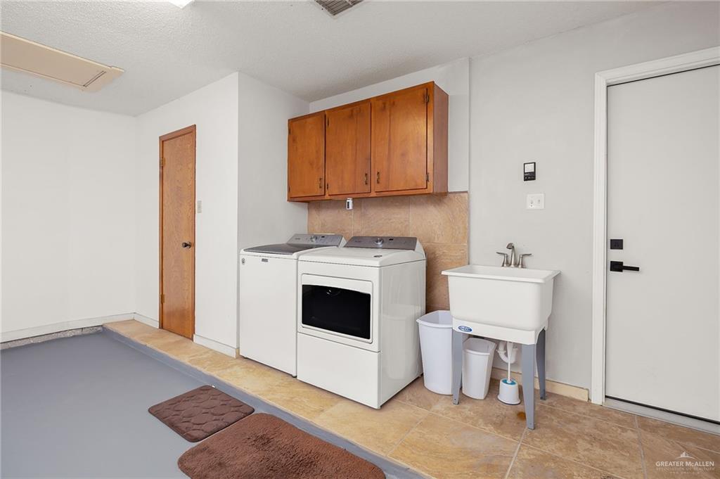 1815 Wilson Street Mission, TX 78572 - Photo 14 of 16 a kitchen with a stove and a white cabinet
