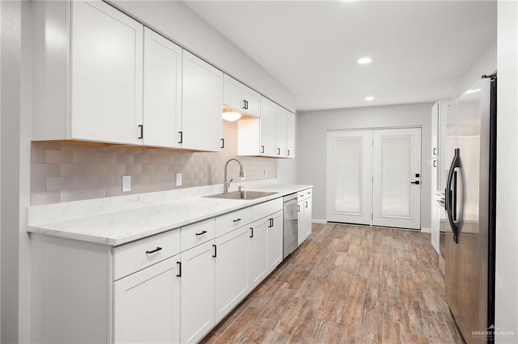 1815 Wilson Street Mission, TX 78572 - Photo 7 of 16 a kitchen with cabinets and wooden floor