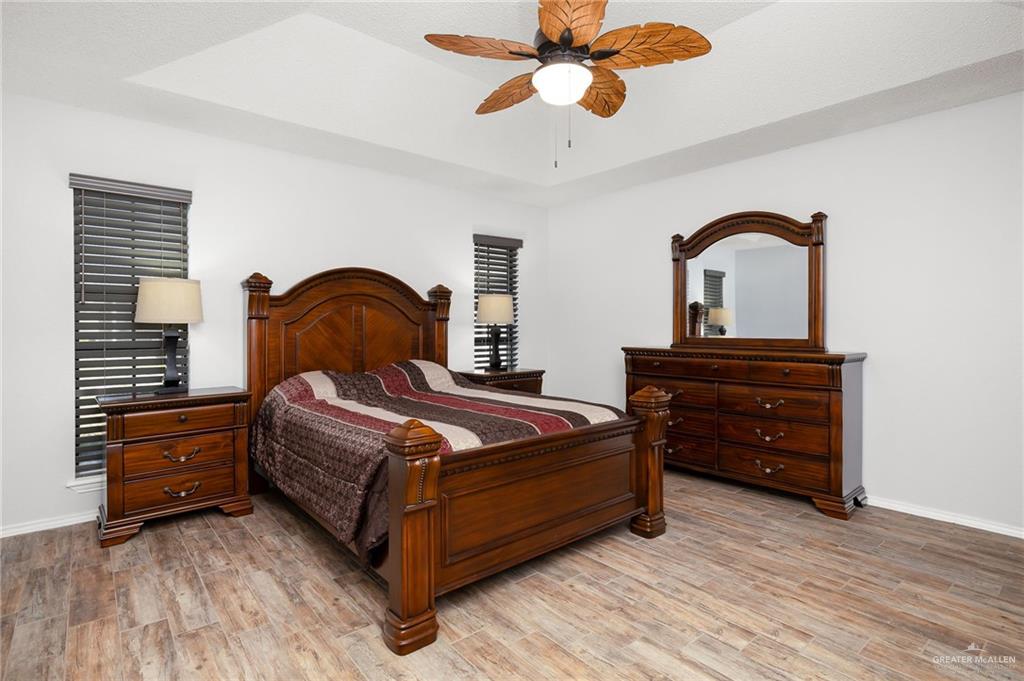 1815 Wilson Street Mission, TX 78572 - Photo 9 of 16 a bedroom with a bed and a dresser with wooden floor