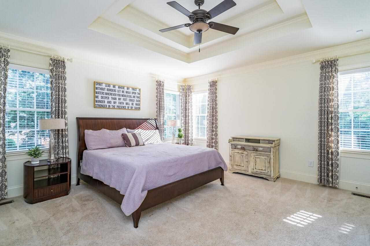 3820 Laurel Hills Road Raleigh, NC 27612 - Photo 14 of 30 First floor owner's suite features a tray ceiling, private entrance and spa-like en suite bath. Owner's Suite