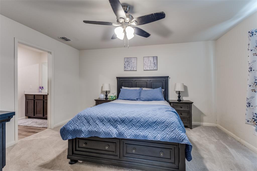 201 Cattlemans Crk Road Newark, TX 76071 - Photo 14 of 25 a bedroom with a bed and a chandelier
