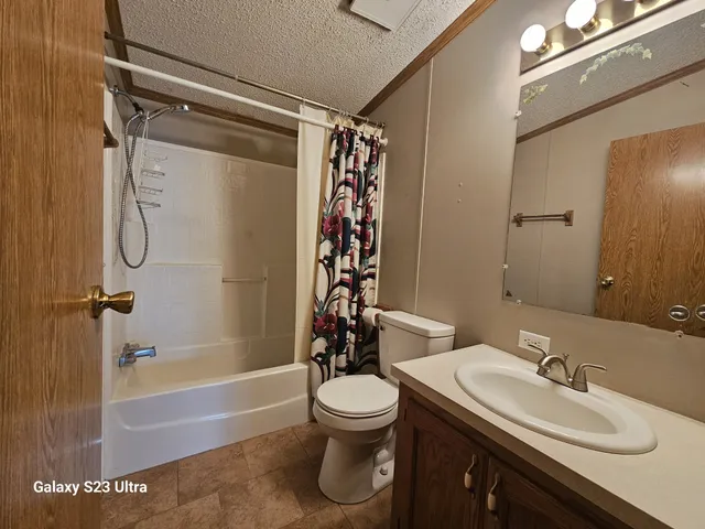 a bathroom with a sink toilet tub and shower