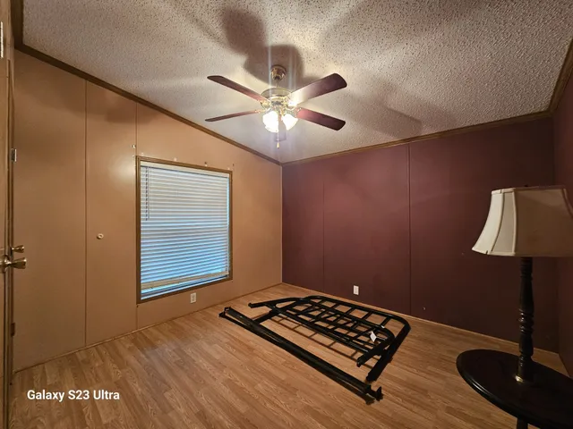 a view of room with window and wooden floor