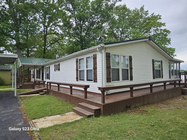 a view of a house with a yard and sitting area