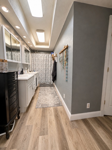 221 Winding Way Road Marble Falls, TX 78654 - Photo 19 of 19 Streamlined vanity with dual sinks creates a functional, organized bathing space for the primary bedroom.