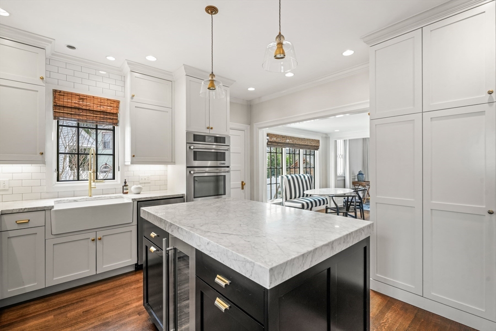 254 Commonwealth Avenue Newton, MA 02467 - Photo 12 of 37 a kitchen with a table chairs sink and refrigerator