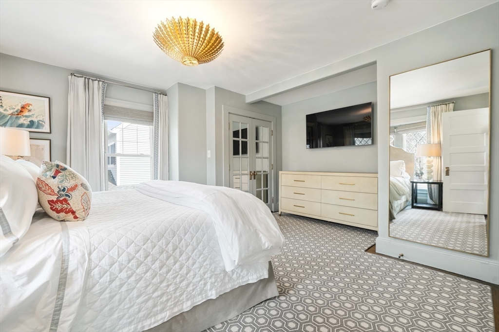 254 Commonwealth Avenue Newton, MA 02467 - Photo 18 of 37 a bedroom with a bed a flat screen tv and dresser