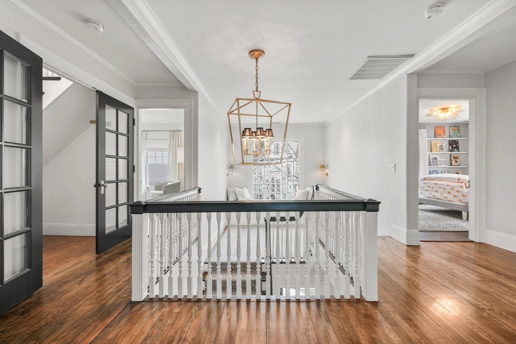 254 Commonwealth Avenue Newton, MA 02467 - Photo 22 of 37 a view of a hallway with wooden floor and windows