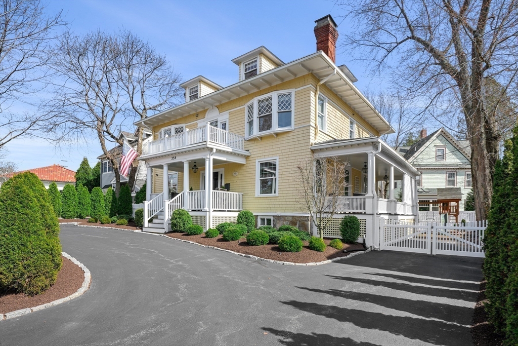 254 Commonwealth Avenue Newton, MA 02467 - Photo 36 of 37 a front view of a house with a yard and a garage
