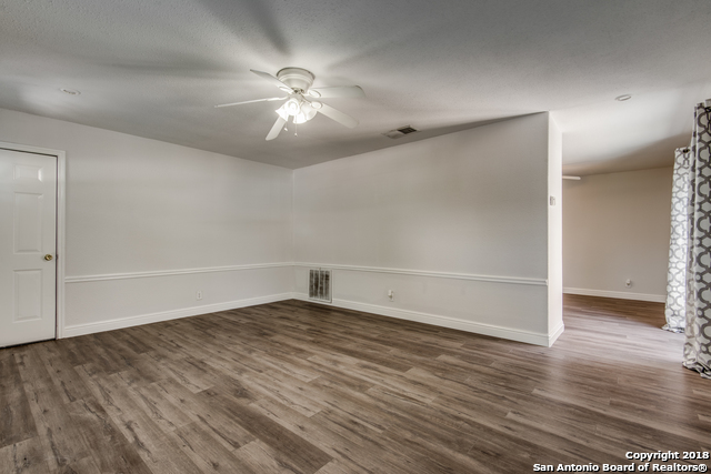 4838 Aspen Wood Kirby, TX 78219 - Photo 4 of 11 a view of an empty room with wooden floor and a ceiling fan