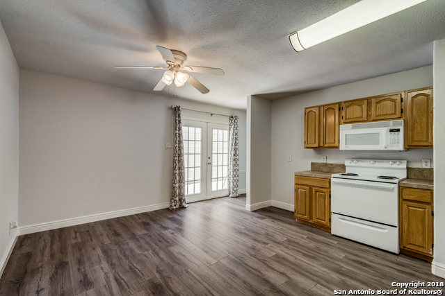 4838 Aspen Wood Kirby, TX 78219 - Photo 5 of 11 a view of a kitchen with a sink cabinet a refrigerator and cabinets