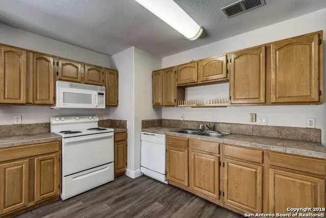 a kitchen with stainless steel appliances granite countertop a sink stove microwave and cabinets