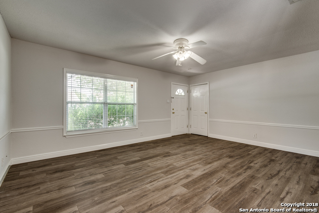 4838 Aspen Wood Kirby, TX 78219 - Photo 10 of 11 an empty room with wooden floor fan and windows