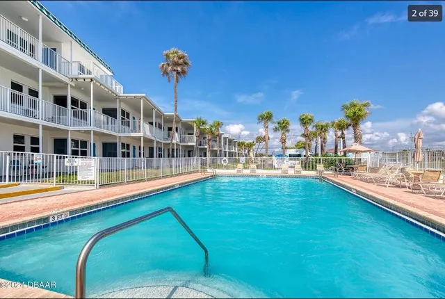 a view of a swimming pool with a lawn chairs
