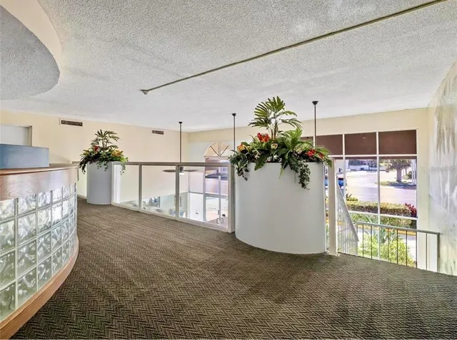 a living room with lots of furniture and a dining table with wooden floor