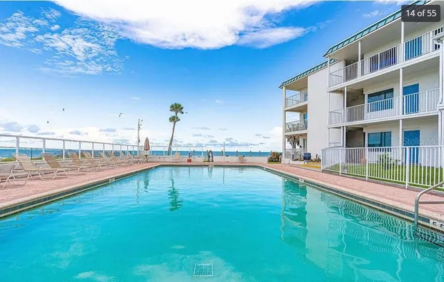 a view of a swimming pool with an outdoor seating