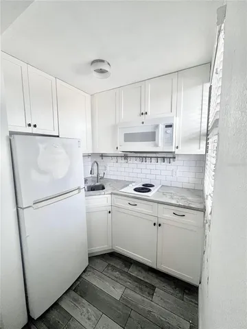 a sink with a potted plant and a window