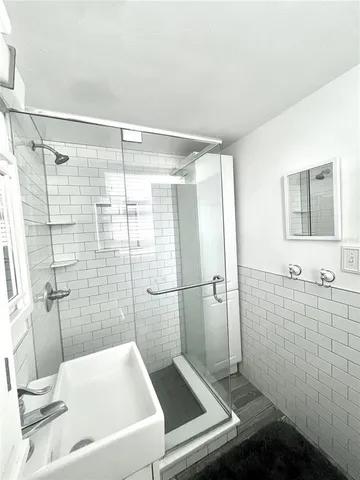 a bathroom with a toilet a sink and a shower
