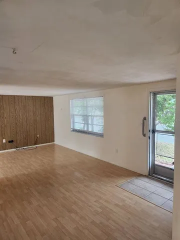 an empty room with windows and closet
